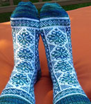 Hand-knit fair isle socks knit with Malabrigo Merino Sock Yarn colors solis and natural